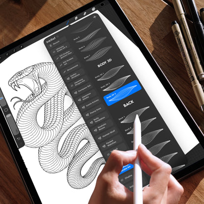 Hand holding an Apple Pencil using the Procreate app on an iPad, displaying a snake drawing created with Procreate brushes. The brush selection panel is open, highlighting the “Snake Body” and “Body 3D” brushes used to build detailed snake scale patterns. The iPad is placed on a wooden table with technical pens in the background.
